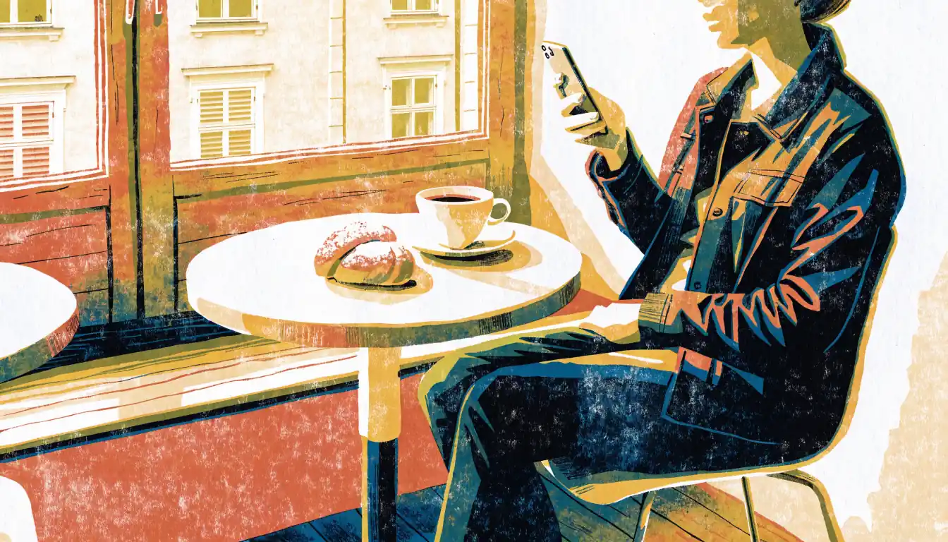 Person in Wiener Café mit Smartphone und Kaffee