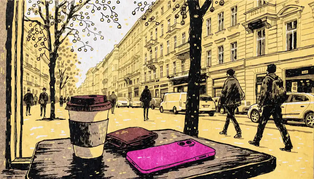 Magentafarbenes Smartphone auf einem Wiener Cafétisch neben Geldbörse und Kaffeetasse.