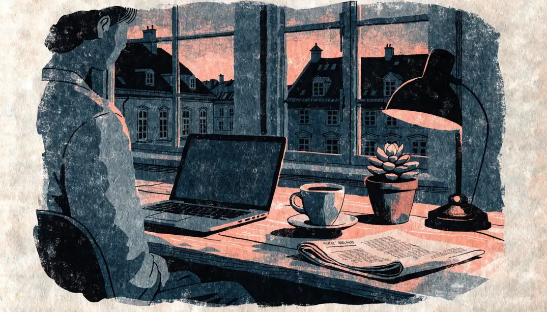 Wiener Heimbüro bei Dämmerung mit Laptop und Kaffeetasse